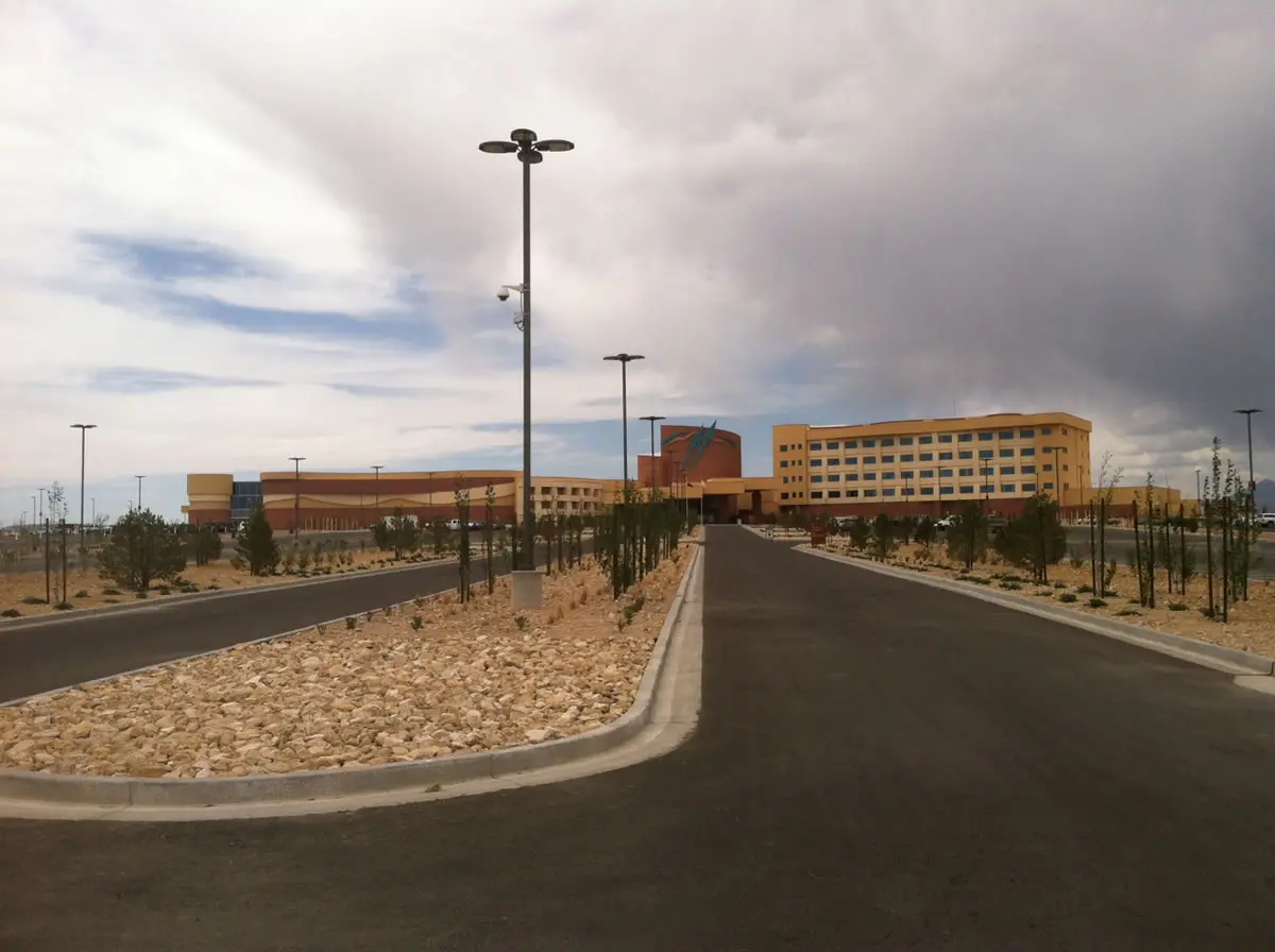 Large building with cloudy sky background.
