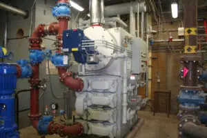 Industrial HVAC system with red and blue pipes.