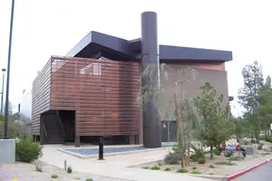 Modern building with trees and pathway.