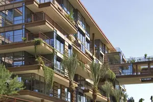 Modern building with glass and balconies.