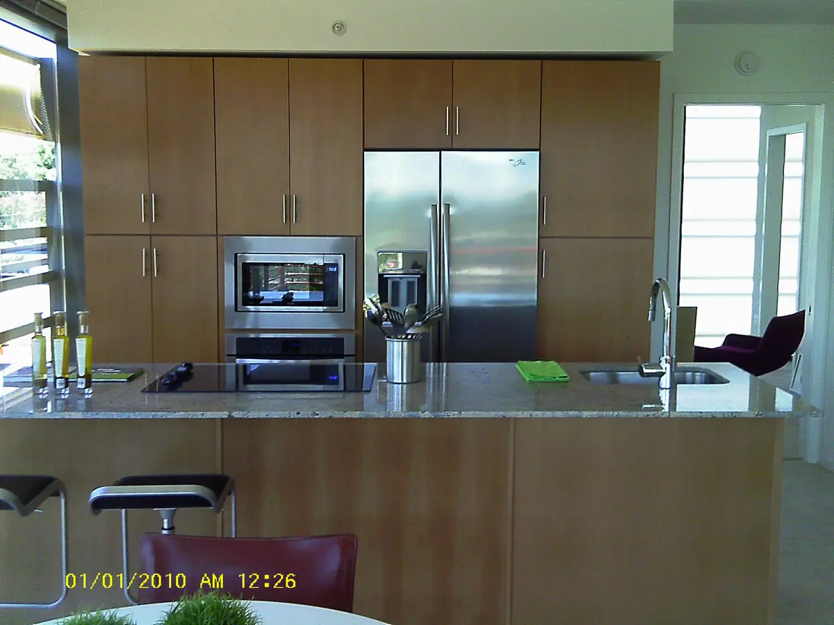 Modern kitchen with wooden cabinets and appliances.