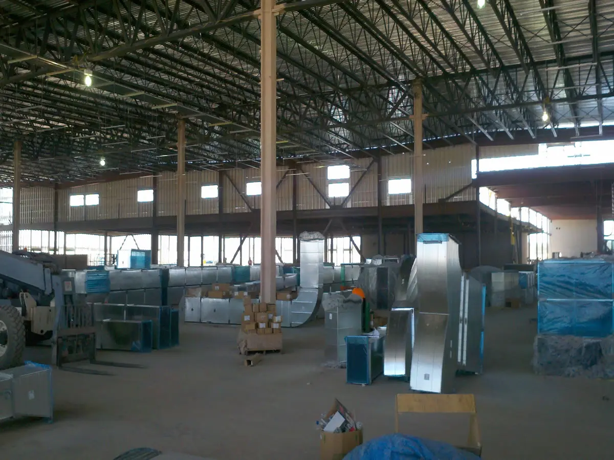Large warehouse interior with industrial equipment.