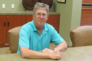 Man sitting at a conference table.
