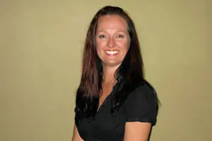 Smiling woman with long brown hair.