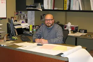 Man sitting at desk with documents.